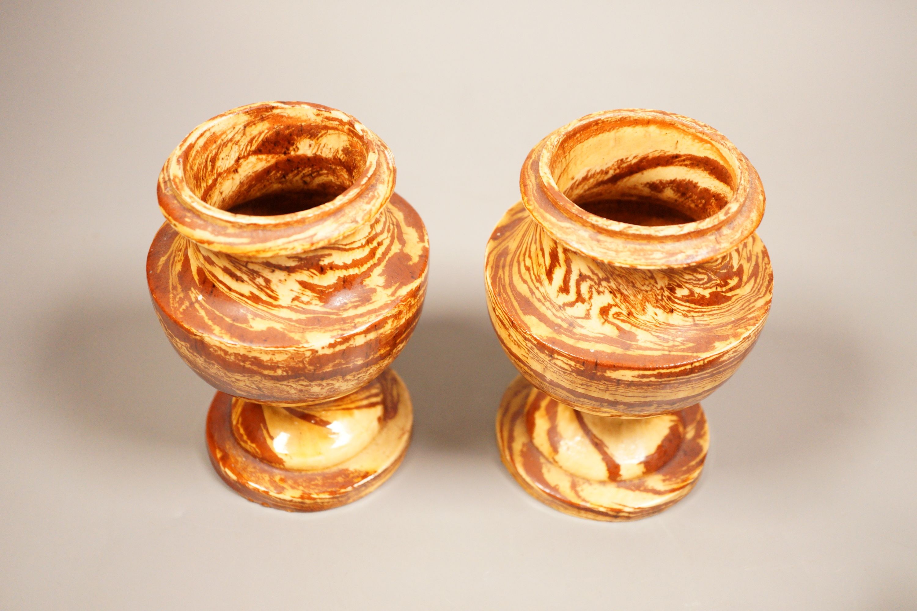 A pair of 19th century 'solid agate' pottery urns 14cm